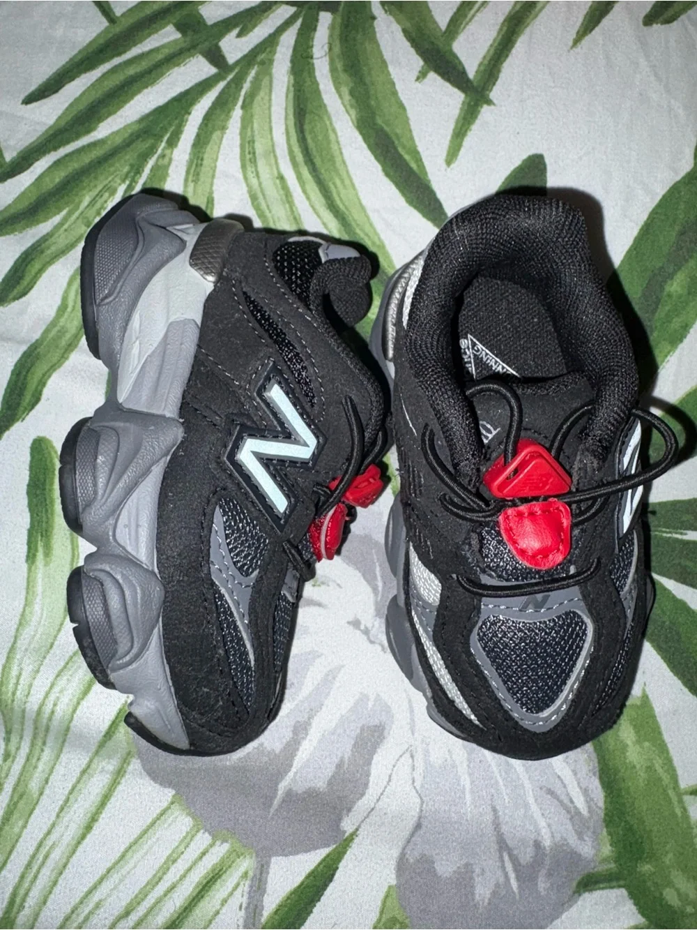 Kids Black and Red Athletic Sneakers one side sole is missing